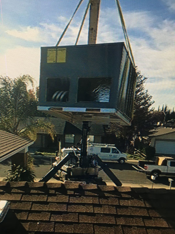 C & M Air Conditioning in Modesto with Crane at Job site